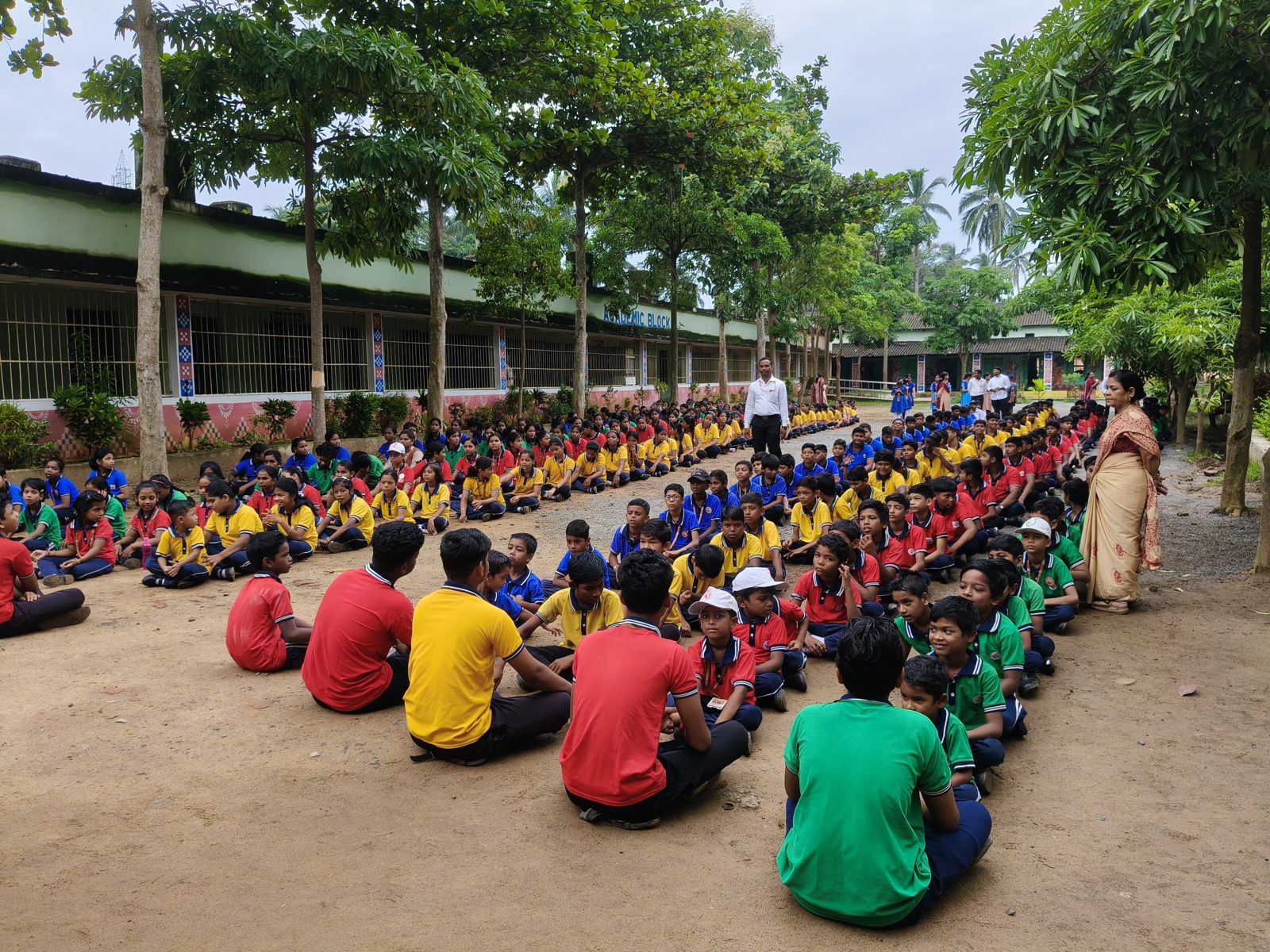 Students seated house-wise on the school ground