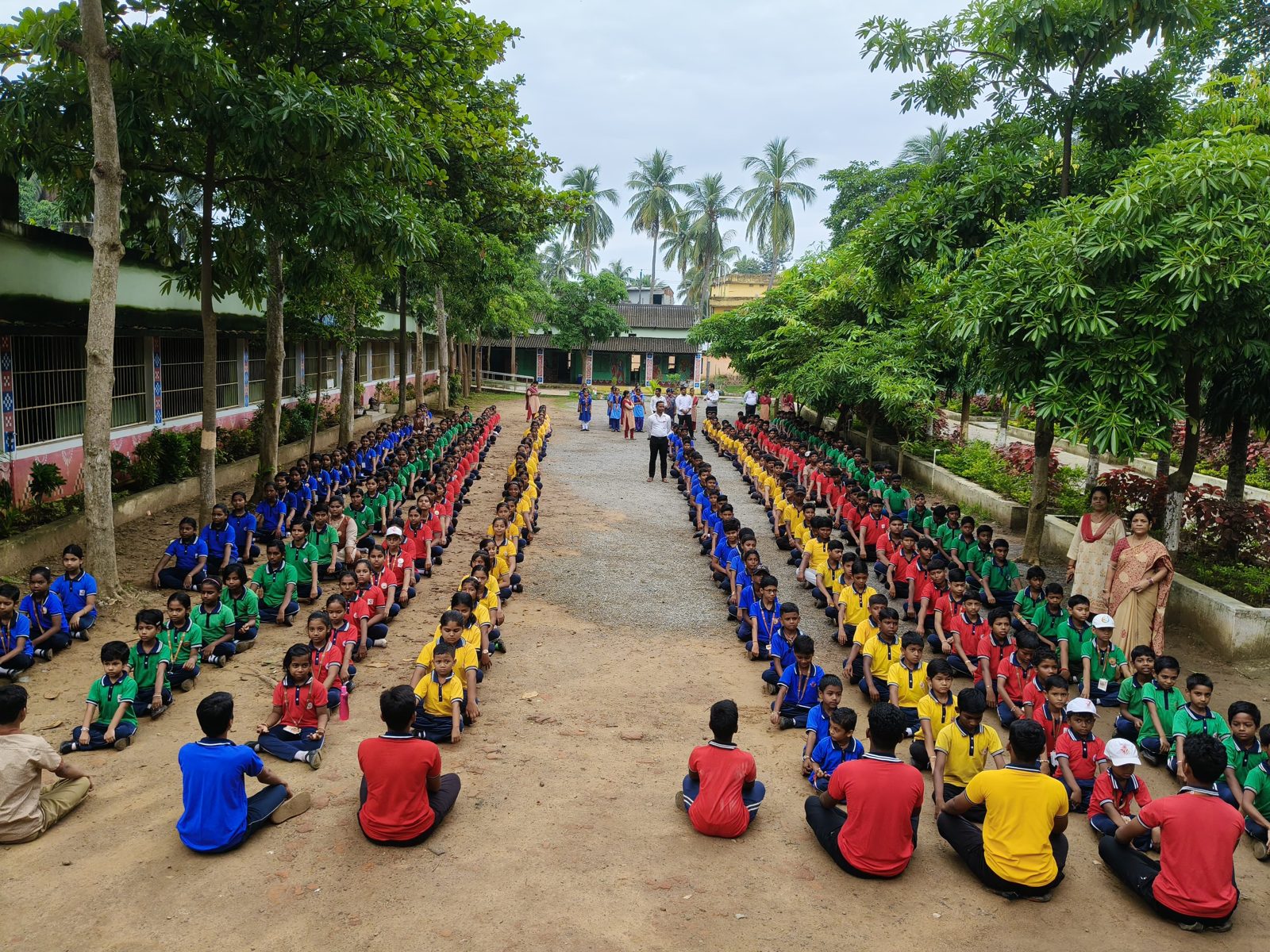 Students seated in house-wise lines