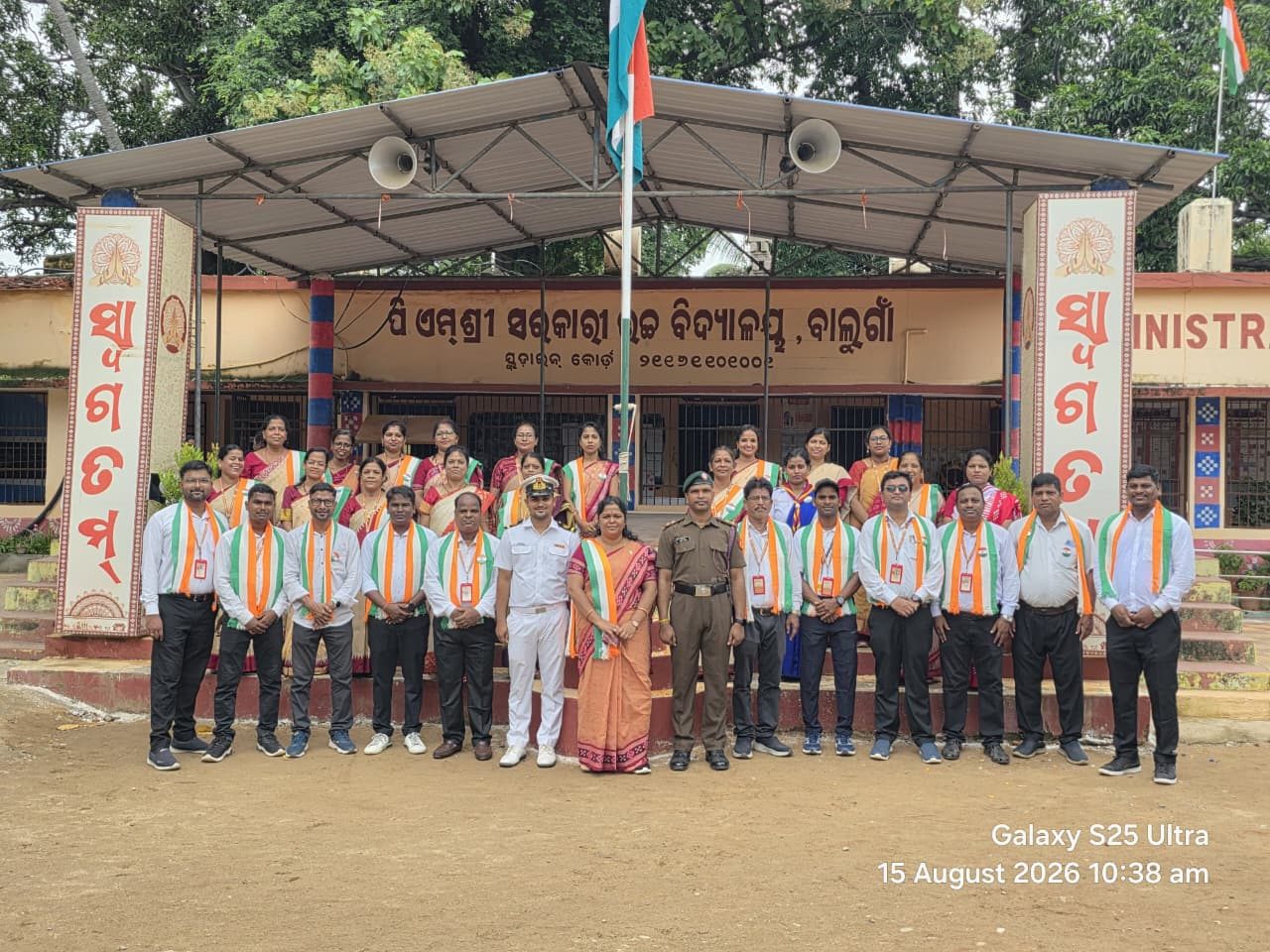 Staff and students with the tricolour in front of the Administrative Block